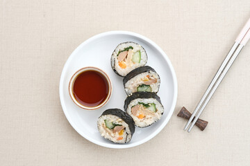 Korean Rolled Gimbap, made of rice, cucumber, tuna, carrot, sausage, crab stick and wrapped with seaweed laver. 
