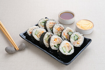 Korean Rolled Gimbap, made of rice, cucumber, tuna, carrot, sausage, crab stick and wrapped with seaweed laver. 
