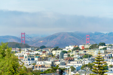 Cloudy suburbs and neighborhood in San Francisco California near Golden Gate Bridge in urban area with cloudy moutain background