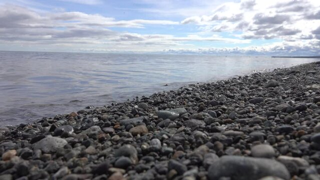 Coast of Anadyr Bay, Bering Sea in summer day. Pebble Beach