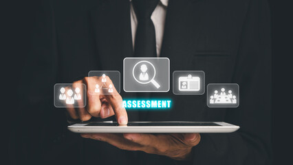 Assessment Analysis Evaluation Measure Business Analytics Concept, Businessman hand using digital tablet with assessment icon on virtual screen.