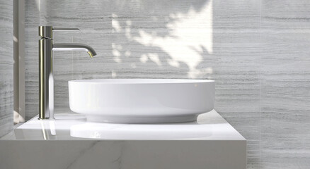 Modern and luxury beige bathroom vanity with white ceramic washbasin in dappled sunlight from...