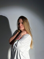 Young beautiful woman with long hair, green eyes in a white t-shirt