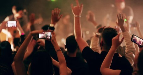 Crowd dancing, phone and rave lights in nightclub or neon festival party. Edm dj, music concert and audience dance with smartphone, streaming and record show stage or dancer celebration in club
