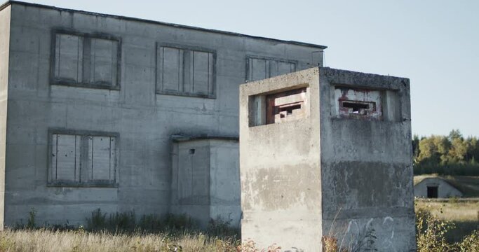A machinegun pillbox stands guard in front of an abandoned nuclear facility with a bunker visible in the background at the special security area of Loring Air Force base near Limestone, Maine.