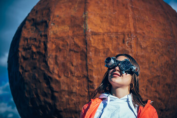 Young girl in a steampunk goggles under the scorching sun. Portrait of post apocalyptic cosplayer...