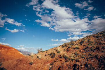Slope of a sandstone mountain under a blue sky. Wild natural landscape.