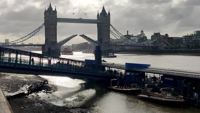 Thames River and Tower Bridge with raised bascules. London UK