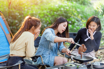 Happy group girls outdoor camping and cooking in nature forest summer holidays.