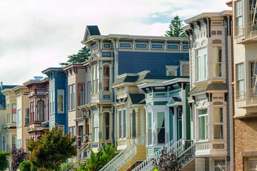Row of colorful houses in modern part of town in San Francisco California with blue and pink and red homes