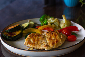 Grilled chicken breast on black peppercorn with mix vegetables plate. Healthy food menu concept