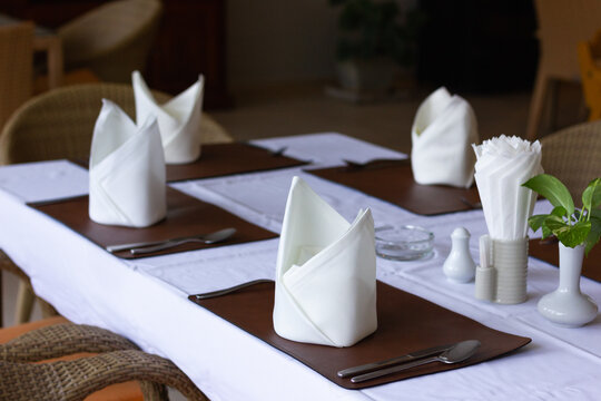 Table setting with folded napkins at fancy restaurant. Special event reception concept