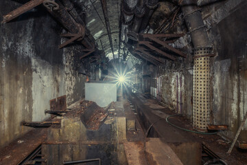 Exploration of an old bunker from the Second World War. A flashlight illuminates the generator room.