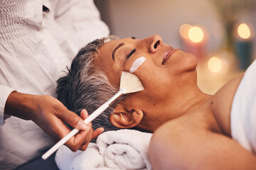 Facial, relax and senior woman at a spa for a wellness, health and skin treatment at a resort. Peace, calm and elderly lady doing a luxury anti aging face mask with a therapist at a zen beauty salon.