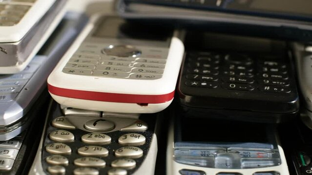 Heap of Used old mobile phone with keyboards. Many types and generations, Reuse and Recycling Electronic waste concept.