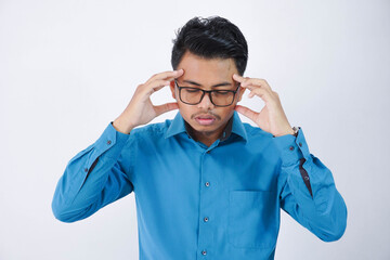 young asian man in wearing blue shirt holding head suffering from headache because migraine and dizzy isolated on white background