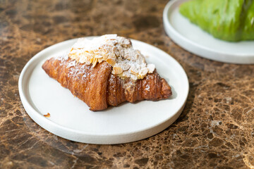 almonds cream croissant on plate