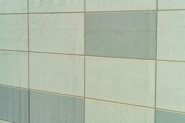 Pattern of a cement wall with shaded squares on the side of a structure or building in the city