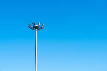 spotlight pole with blue sky