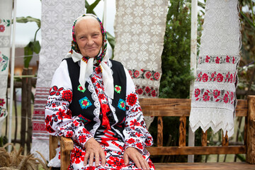 An old Belarusian or Ukrainian woman in an embroidered shirt. Slavic elderly woman in national...