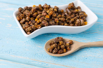 bee parchment in a wooden spoon, close-up. Vitamins, benefits.