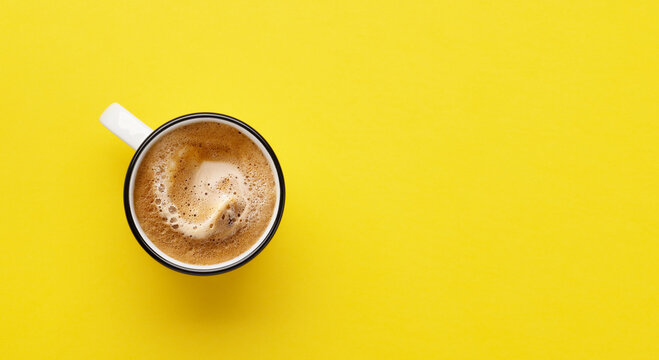 Espresso coffee on yellow background