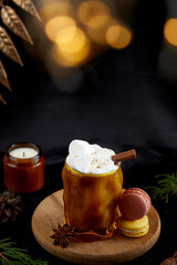 Aesthetics Christmas Viennese coffee with whipped cream, marshmallows, cinnamon and cardamom among Christmas decorations.