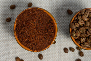 Ground and whole-grain coffee on a light background.