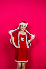 Smiling Asian Woman Posing on an Isolated Red Background With Christmas Attire