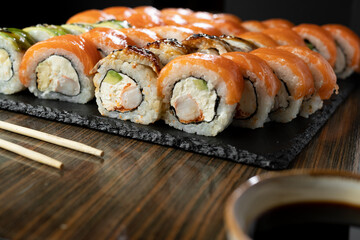 Sushi Set with salmon, shrimp and sushi rolls philadelphia served on wooden table. Japanese Food