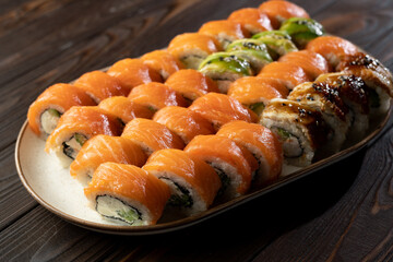 Sushi roll set Philadelphia with salmon, avocado, cream cheese on wooden background. Sushi menu. Japanese food