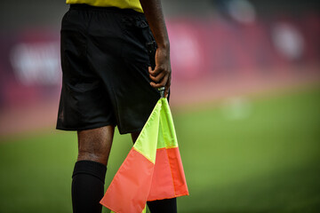 Assistant referee moving along the sideline during a soccer match