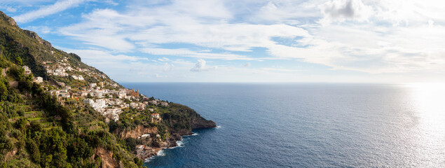 Fototapeta na wymiar Touristic Town, Vettica Maggiore, on Rocky Cliffs and Mountain Landscape by the Tyrrhenian Sea. Amalfi Coast, Italy. Panorama