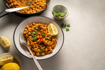 Chickpea dish with curry, cooked chickpeas with spices and herbs. Vegetarian food, copy space.
