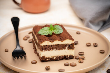 Coffee tiramisu and coffee beans on the plate