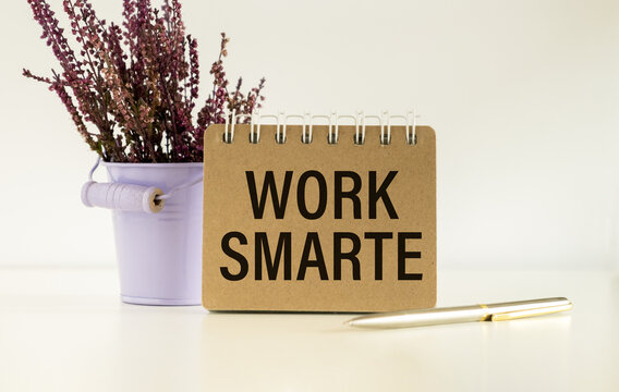 WORK SMARTER text on a notebook on white white background , business concept