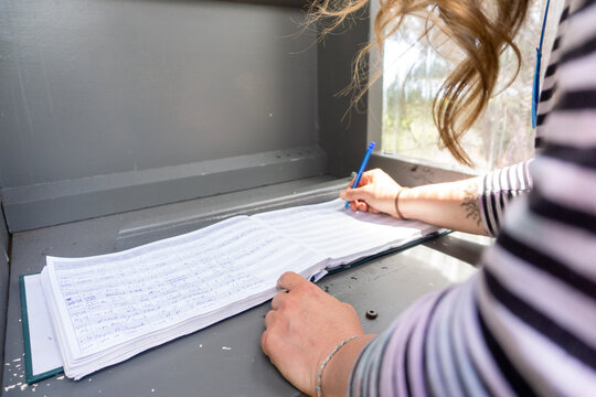 Woman signing registrar for the cape to cape track in western australia, women signing book. 