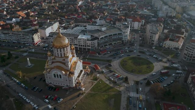 Panorama Aerial drone flight around a roundabout and the Orthodox Church Catedrala Sf&acirc;ntul Ioan Botezătorul and castle Cetatea Făgărașului of Fagaras in Romania - Făgăraș in Rom&acirc;nia - bird view