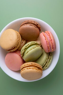 Macaroons colorful cookies. Macarons in bowl, french sweet dessert, top view.