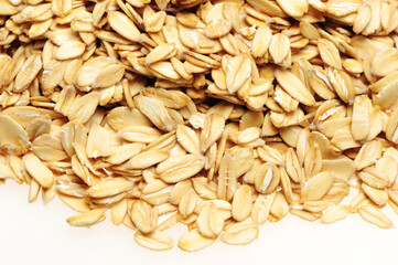 Oat flakes pile on white background 