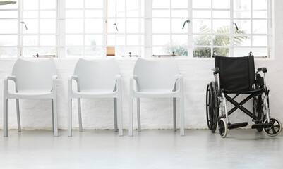 Diversity, inclusive and a row of white chairs with a black wheelchair in a waiting room in the...