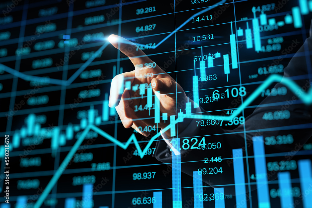 Poster close up of businessman hand pointing at glowing business chart hologram and index on blurry backgro