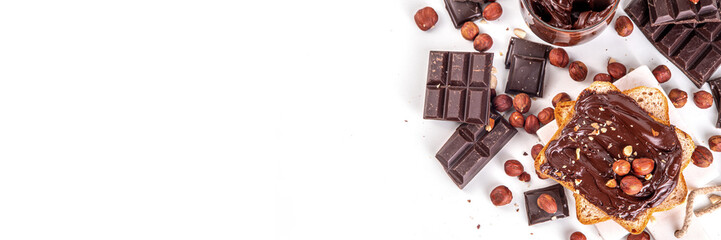 Bread with chocolate hazelnuts paste cream. Traditional american European sweet breakfast dope snack. Sandwiches with jar of chocolate nut cream, hazelnuts and chocolate slices, on white background