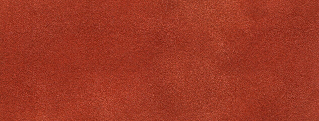 Texture of velvet matte dark orange background, macro. Suede ginger fabric with pattern.