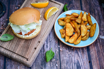 Homemade Salmon Burger with Tartar Sauce and wedges potatoes 