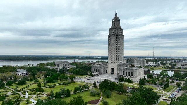 Louisiana State Capitol building in Baton Rouge, LA. Mississippi River in distance. Rising aerial.
