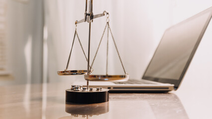 Justice and law concept.Male judge in a courtroom with the gavel, working with, computer and docking keyboard, eyeglasses, on table in morning light