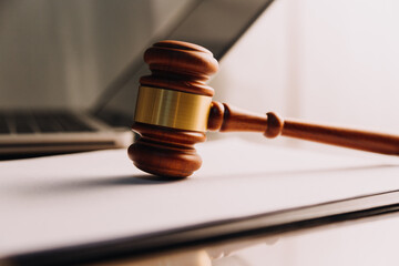 Justice and law concept.Male judge in a courtroom with the gavel, working with, computer and...