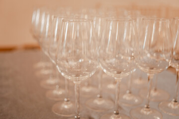 Stock of empty wine glasses ready to use. Close up