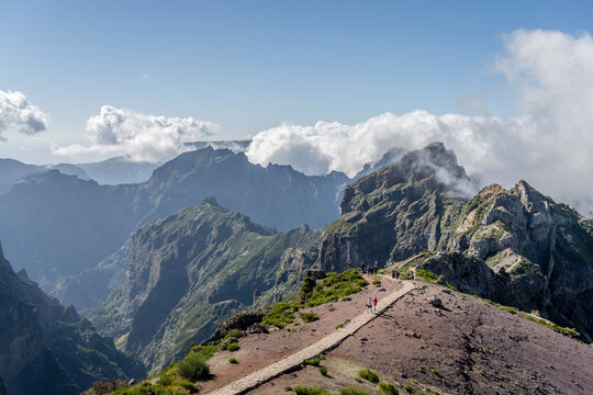 path on barren slope standing out of clouds north of Miradouro de Areeiro peak, Madeira